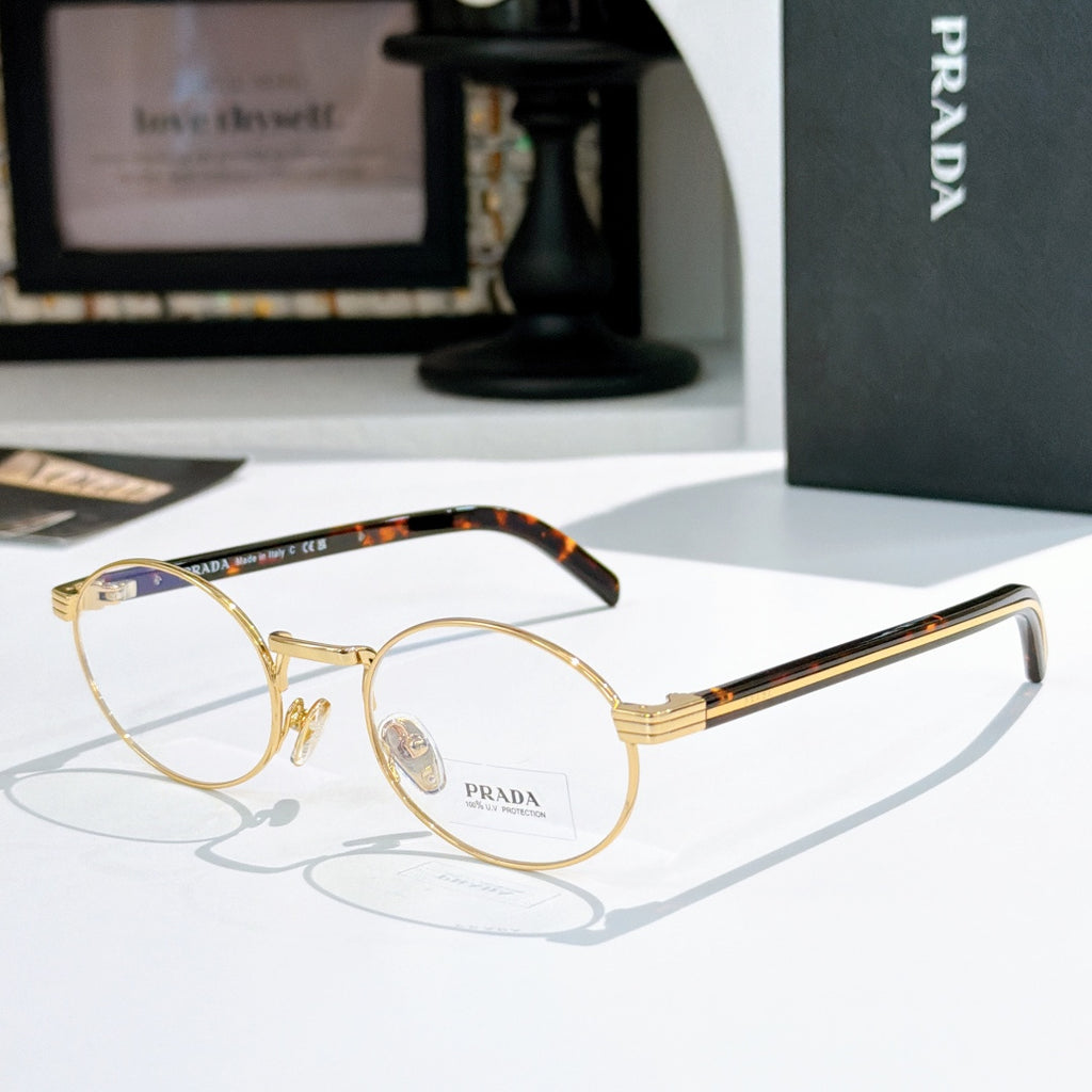 Prada eyeglasses with round gold frames and tortoiseshell temple tips