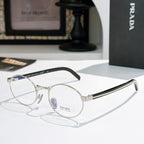 Prada eyeglasses with round gold metal frames and blue-tinted lenses