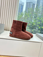 Women’s reddish-brown suede ankle boots, angled pair with Balenciaga logo patch
