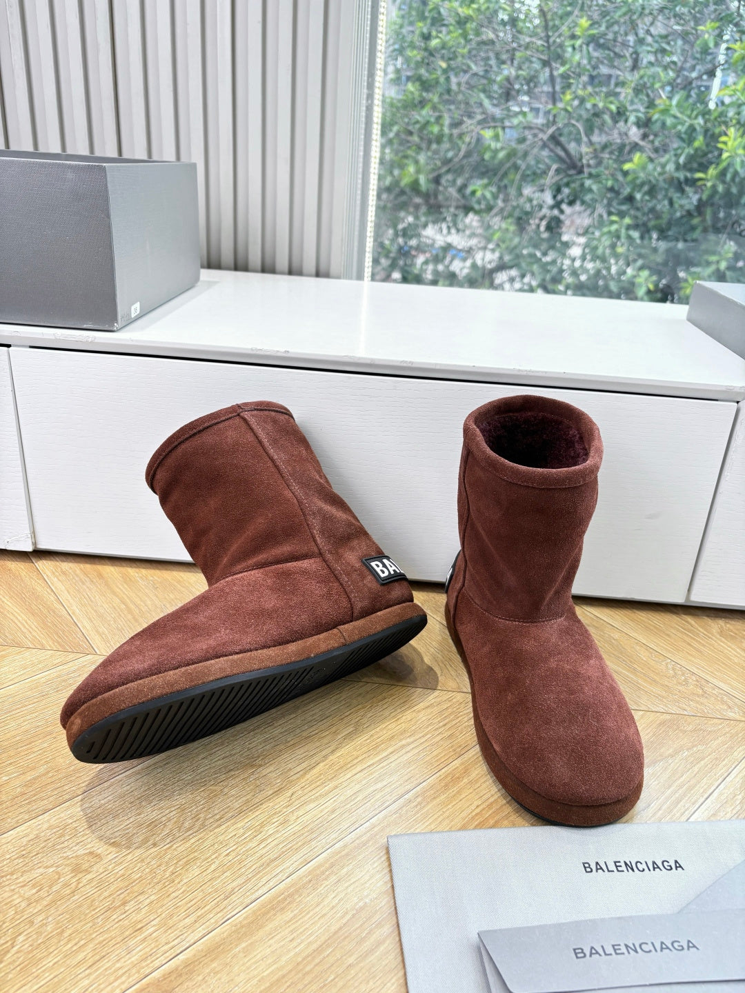 Women’s reddish-brown suede ankle boots with rubber sole, side angle view