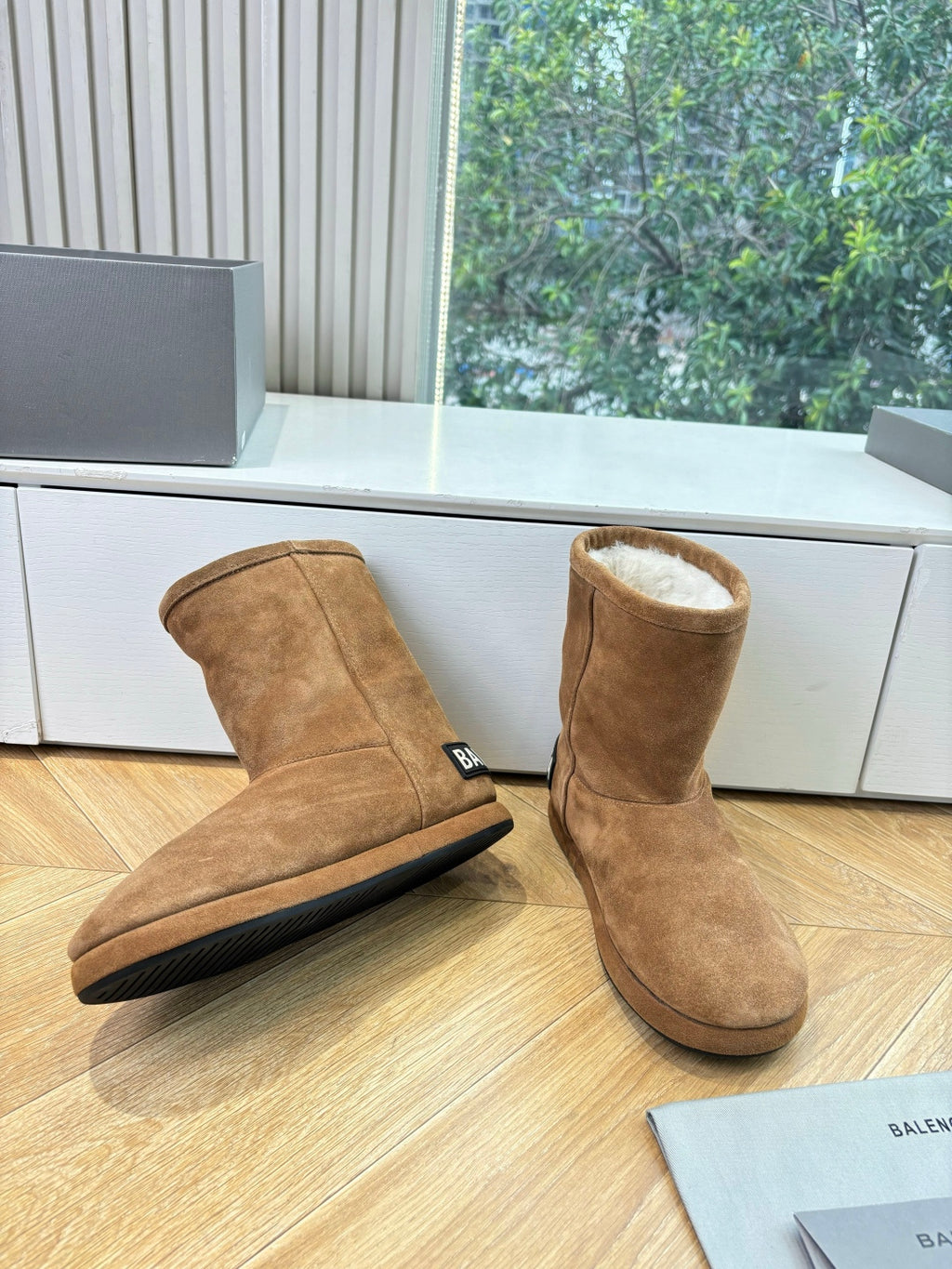 Tan suede ankle boots with shearling lining and black rubber sole