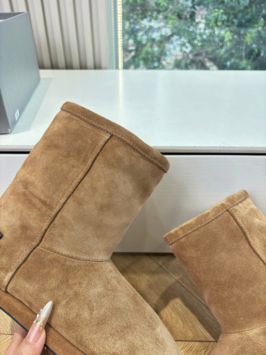 Tan suede ankle boots with tall shaft and seam stitching detail