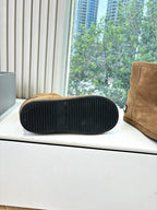 Tan suede ankle boot sole view with black rubber tread and heel