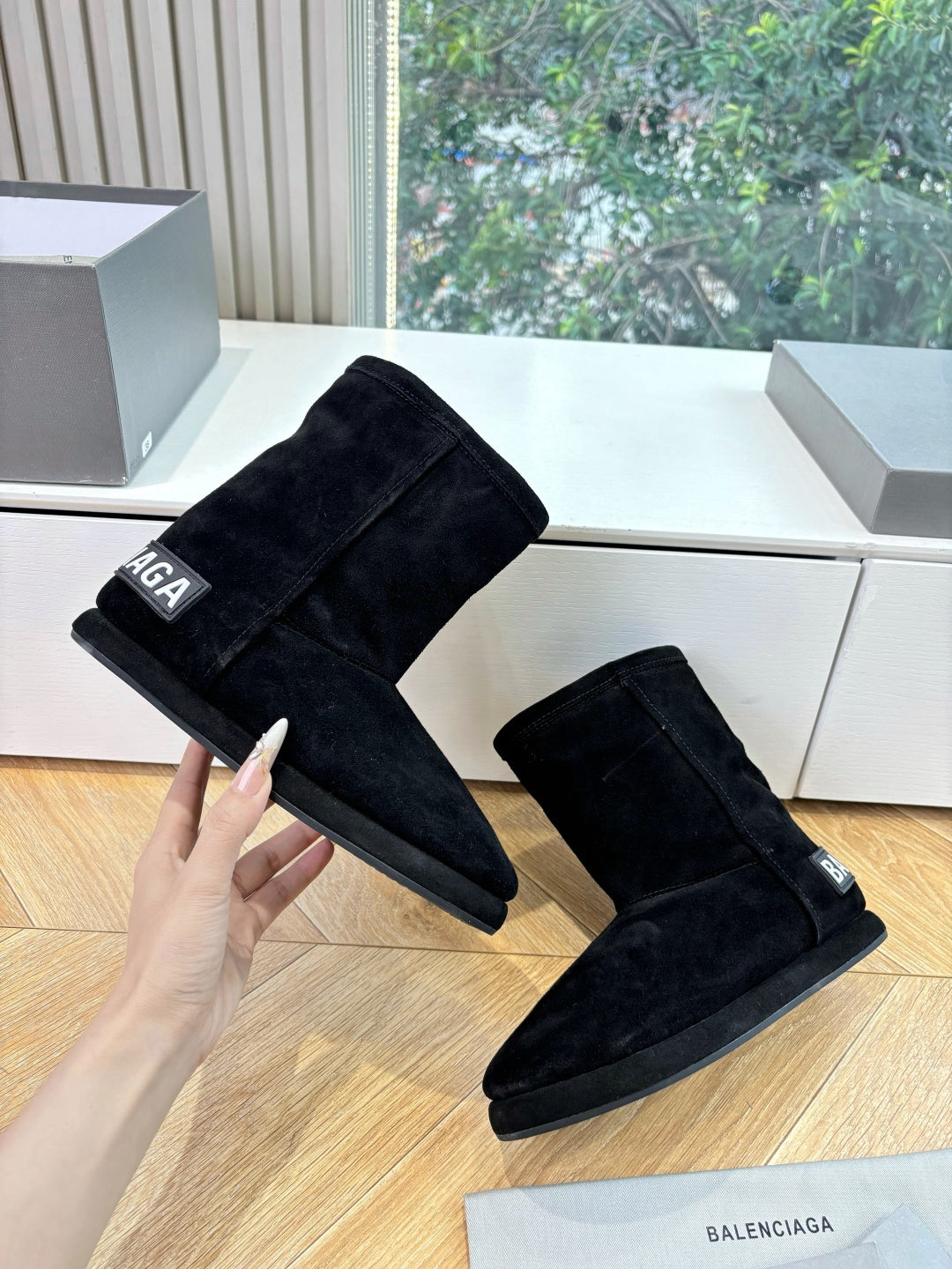 Black suede ankle boots, low stacked heel, logo detail, angled pair view