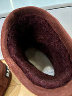 Women’s reddish-brown suede ankle boot opening with dark lining close-up