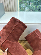 Women’s reddish-brown suede ankle boots, close-up of boot uppers and rounded toe