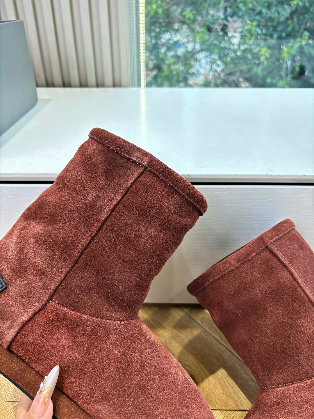 Women’s reddish-brown suede ankle boots, close-up of boot uppers and rounded toe