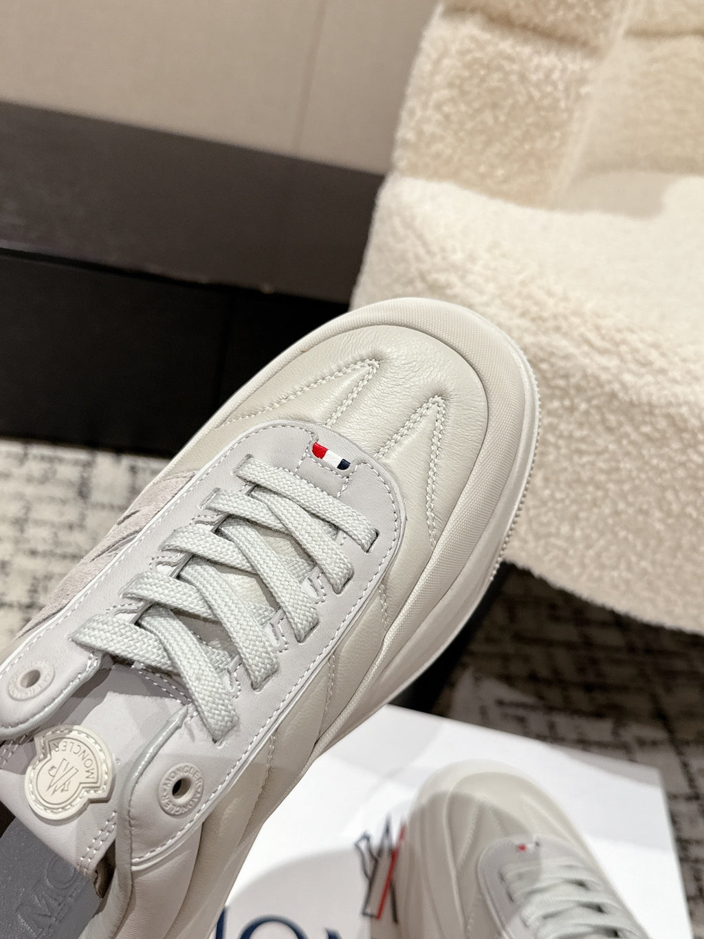 White sneaker toe and lace-up panel, stitched detailing and Moncler patch