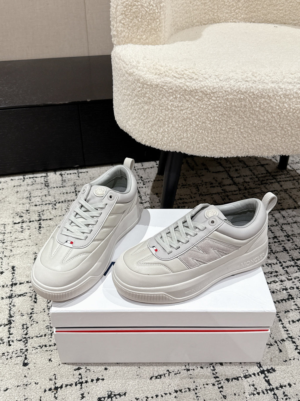 White low-top sneakers pair view, lace-up front and logo on tongue