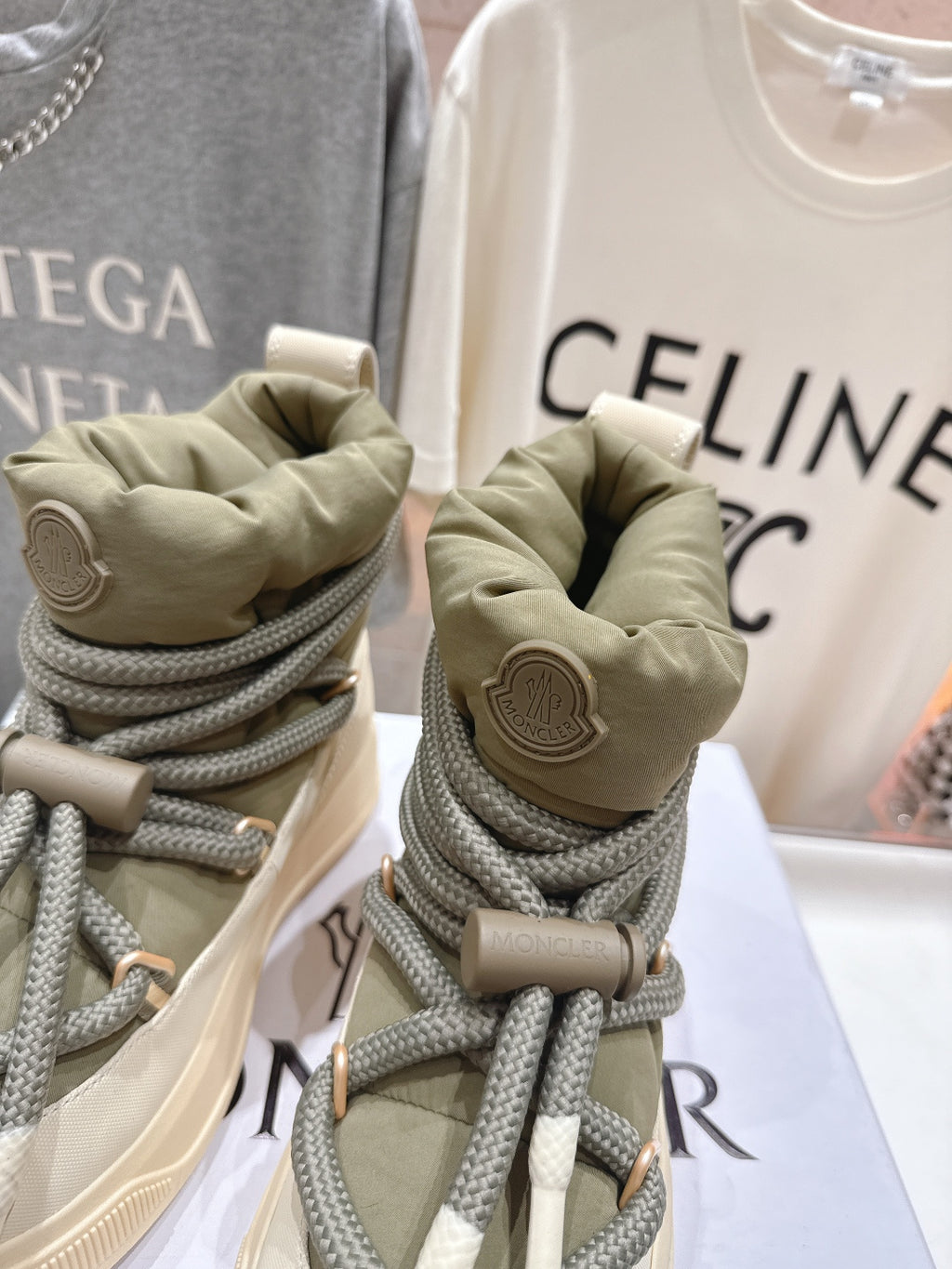 Moncler sneakers close-up of heels, beige with olive laces and logo patch
