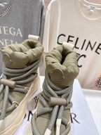 Moncler sneakers close-up of heels, beige with olive laces and logo patch