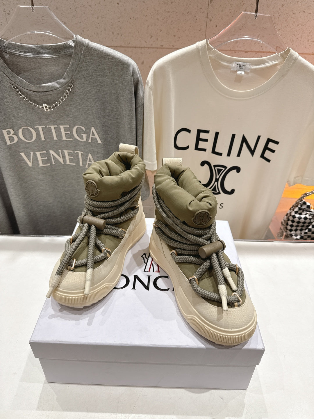 Moncler sneakers pair, beige uppers with olive laces and thick rubber sole