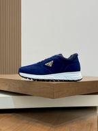 Prada unisex suede sneakers in dark blue, side view with white sole and logo