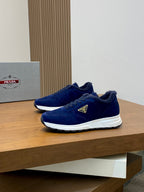 Prada unisex suede sneakers in dark blue, front three-quarter view
