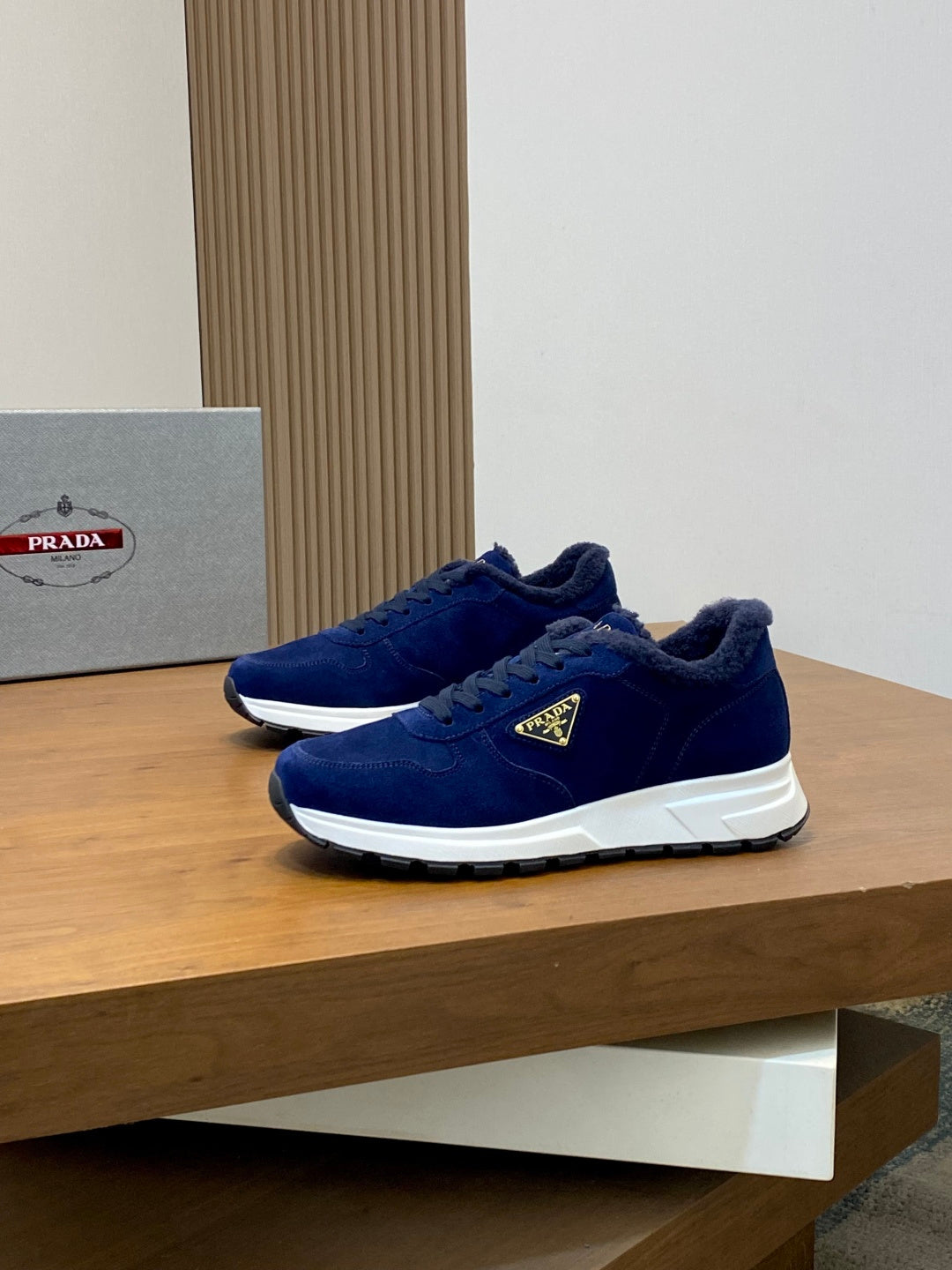 Prada unisex suede sneakers in dark blue, front three-quarter view