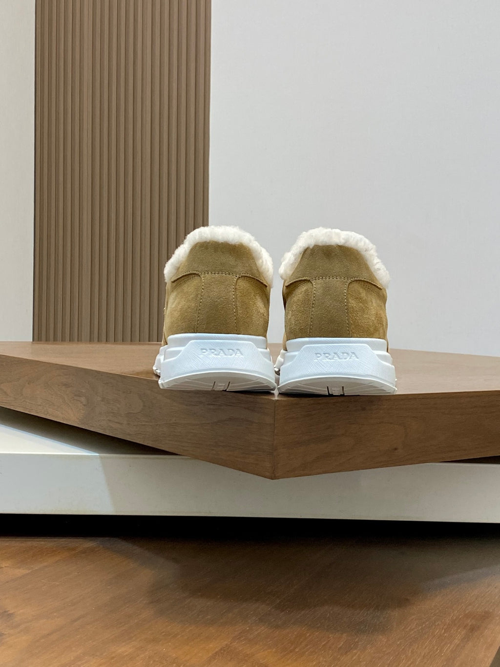 Prada unisex tan suede sneakers with white shearling lining and rubber heel backs