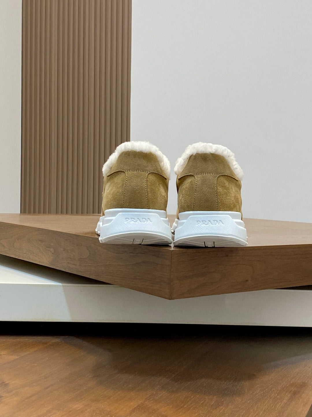 Prada unisex tan suede sneakers with white shearling lining and rubber heel backs