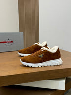 Brown suede lace-up sneakers with shearling lining and white rubber sole, logo patch
