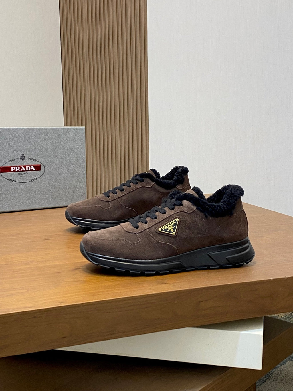 Prada lace-up sneakers in brown suede with black faux-fur lining and green logo patch