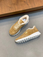 Prada unisex tan suede sneakers pair with white laces, shearling trim, and tread sole