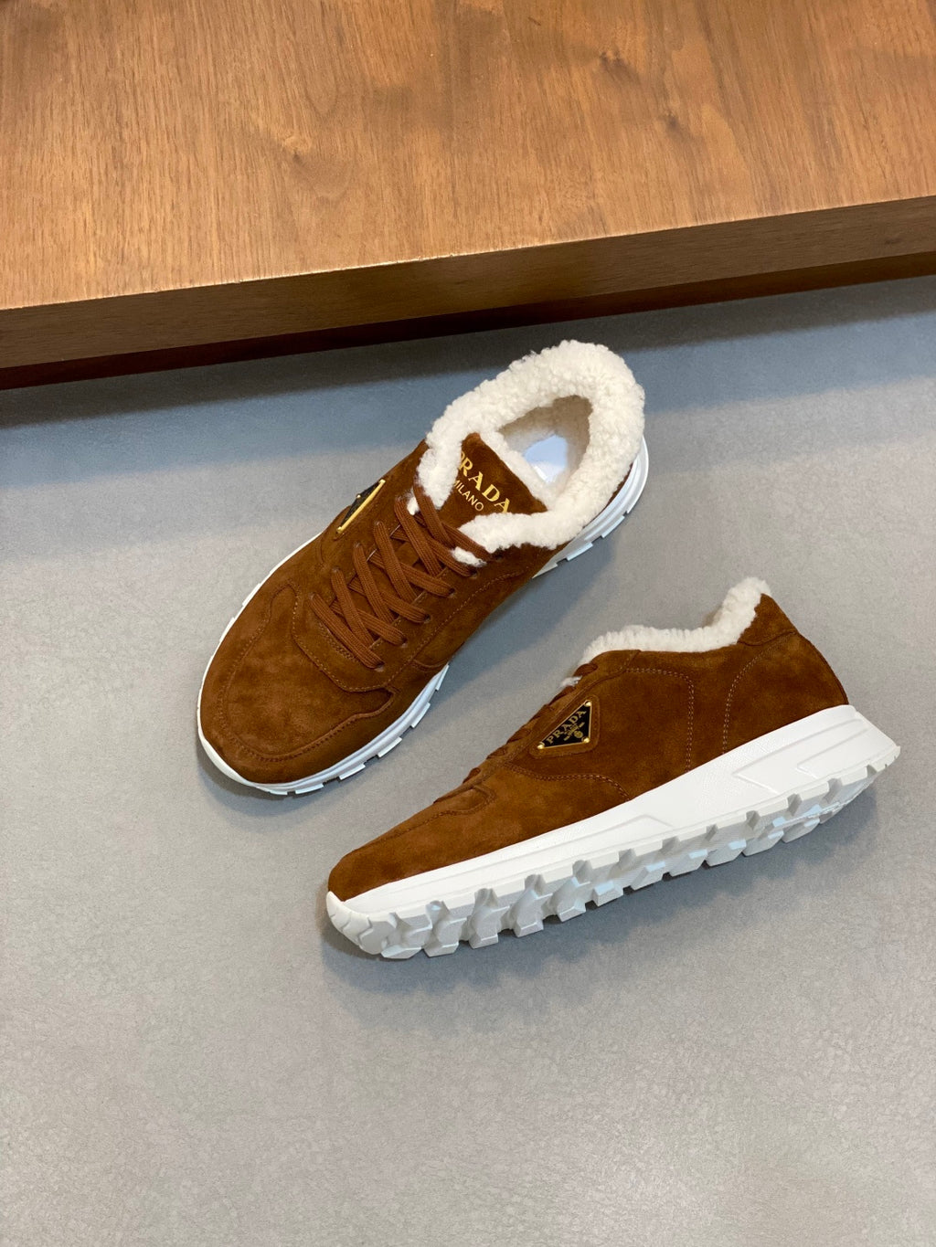 Pair of brown suede lace-up sneakers with shearling lining and white sole, Prada