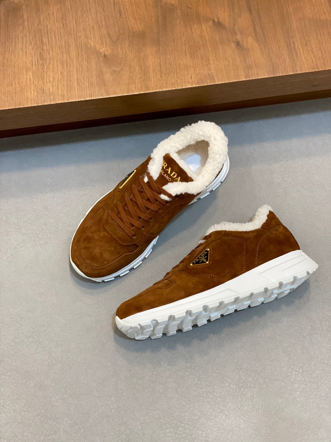 Pair of brown suede lace-up sneakers with shearling lining and white sole, Prada