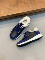 Pair of Prada unisex lace-up sneakers in dark blue with sherpa lining and white sole.