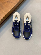 Prada unisex sneakers in dark blue with white sole and plush sherpa collar, lace-up.
