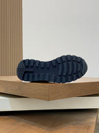Prada sneaker outsole view with dark tread pattern on rubber sole