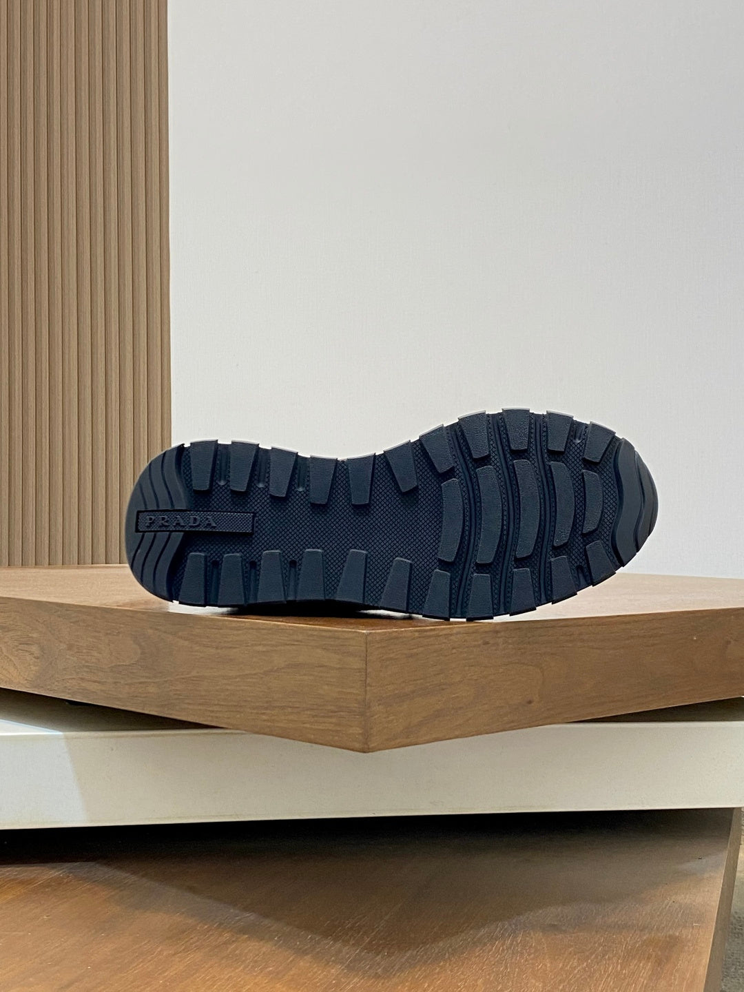 Prada sneaker outsole view with dark tread pattern on rubber sole