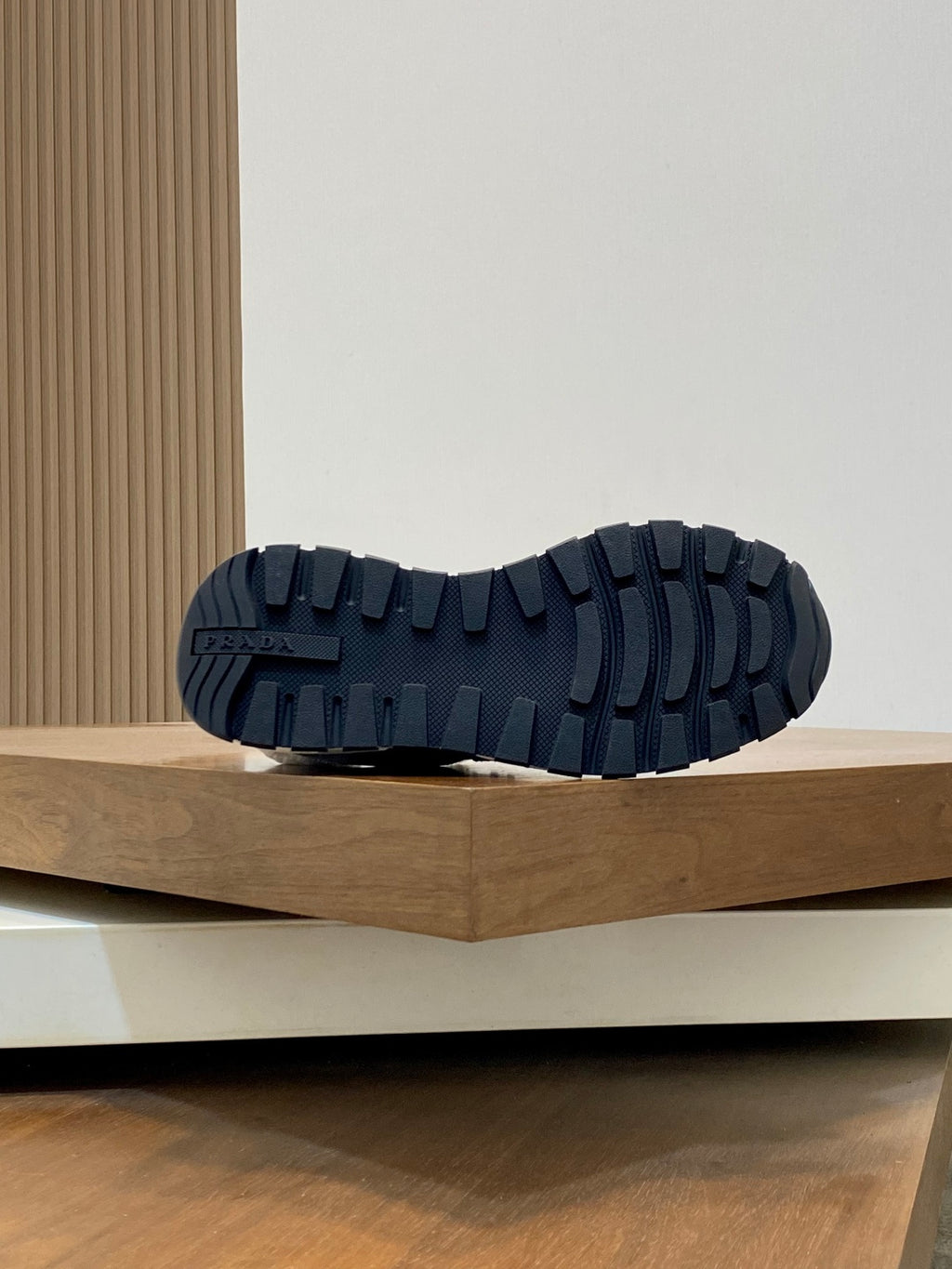Prada unisex sneakers outsole view; dark tread sole with deep grooves