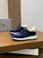 Prada unisex sneakers on display: dark blue with plush lining, white sole, lace-up closure.