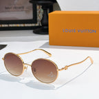 Round sunglasses with gold frame and rose-tinted gradient lenses, rhinestone detail at lens