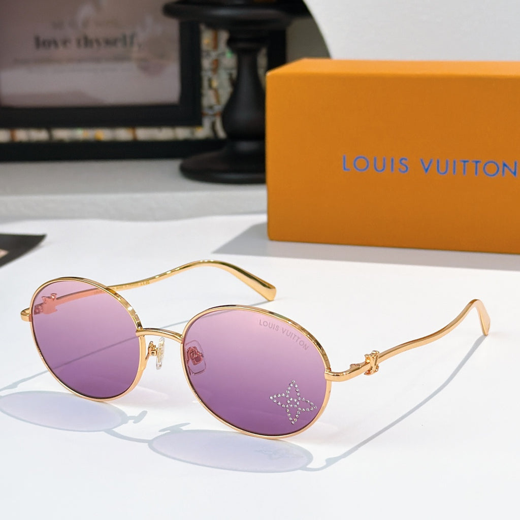 Round sunglasses with gold frame and purple gradient lenses, rhinestone detail at lens