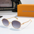 Round sunglasses with gold frame and blue gradient lenses, rhinestone detail at lens