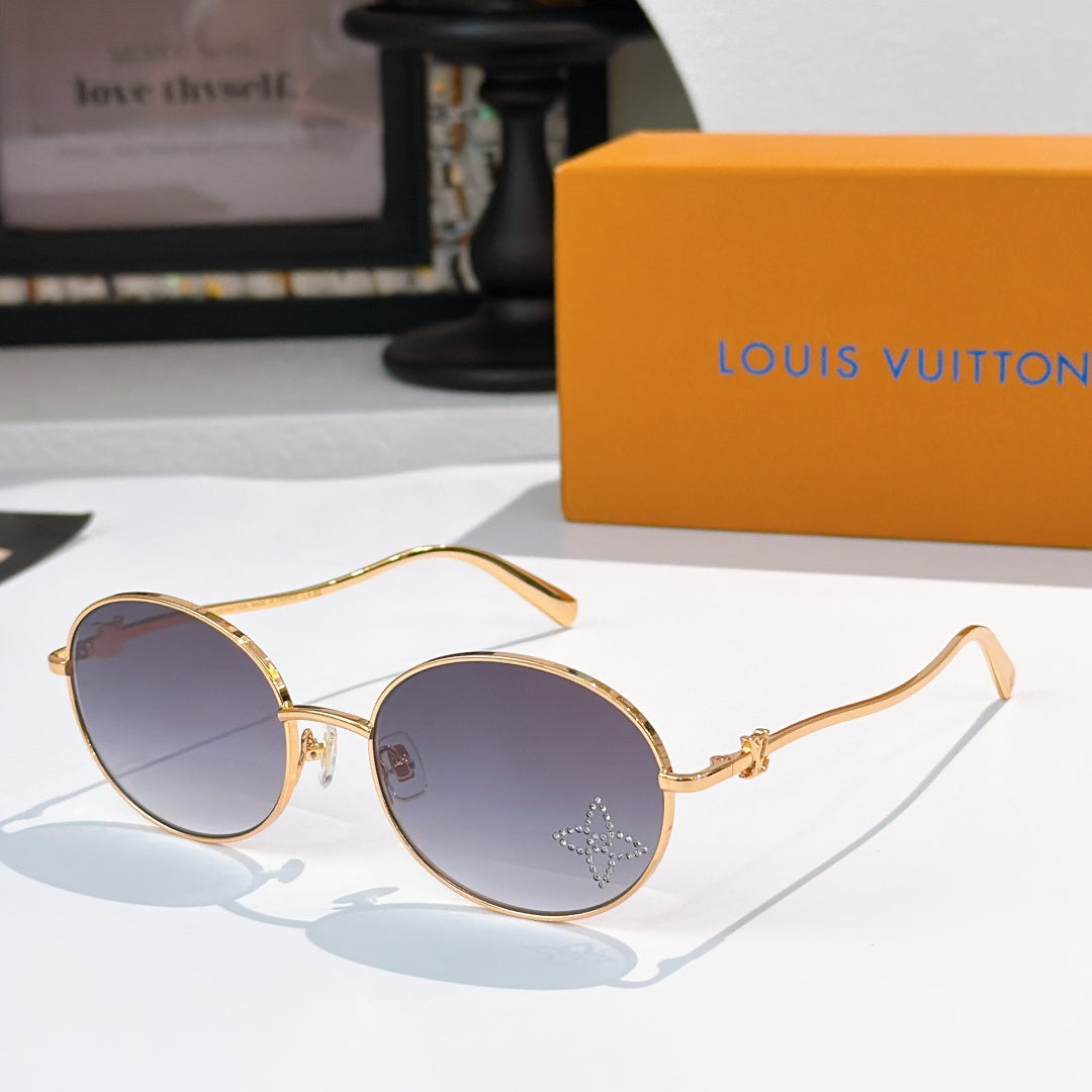 Round sunglasses with gold frame and blue gradient lenses, rhinestone detail at lens