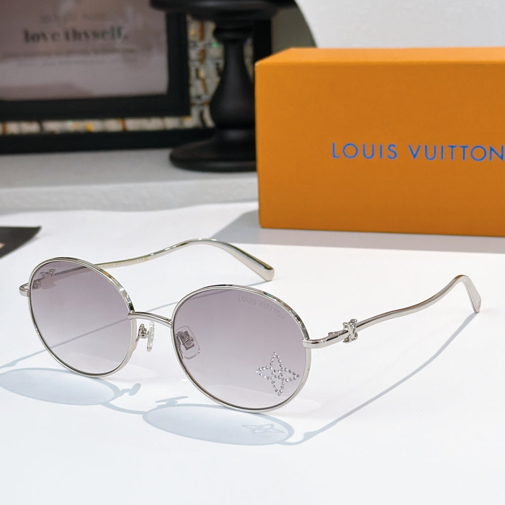 Round sunglasses with silver frame and lavender gradient lenses, rhinestone detail at lens