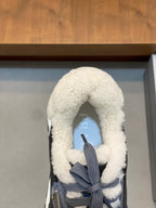 Prada unisex sneakers close-up of toe area; dark gray shoe with shearling hood