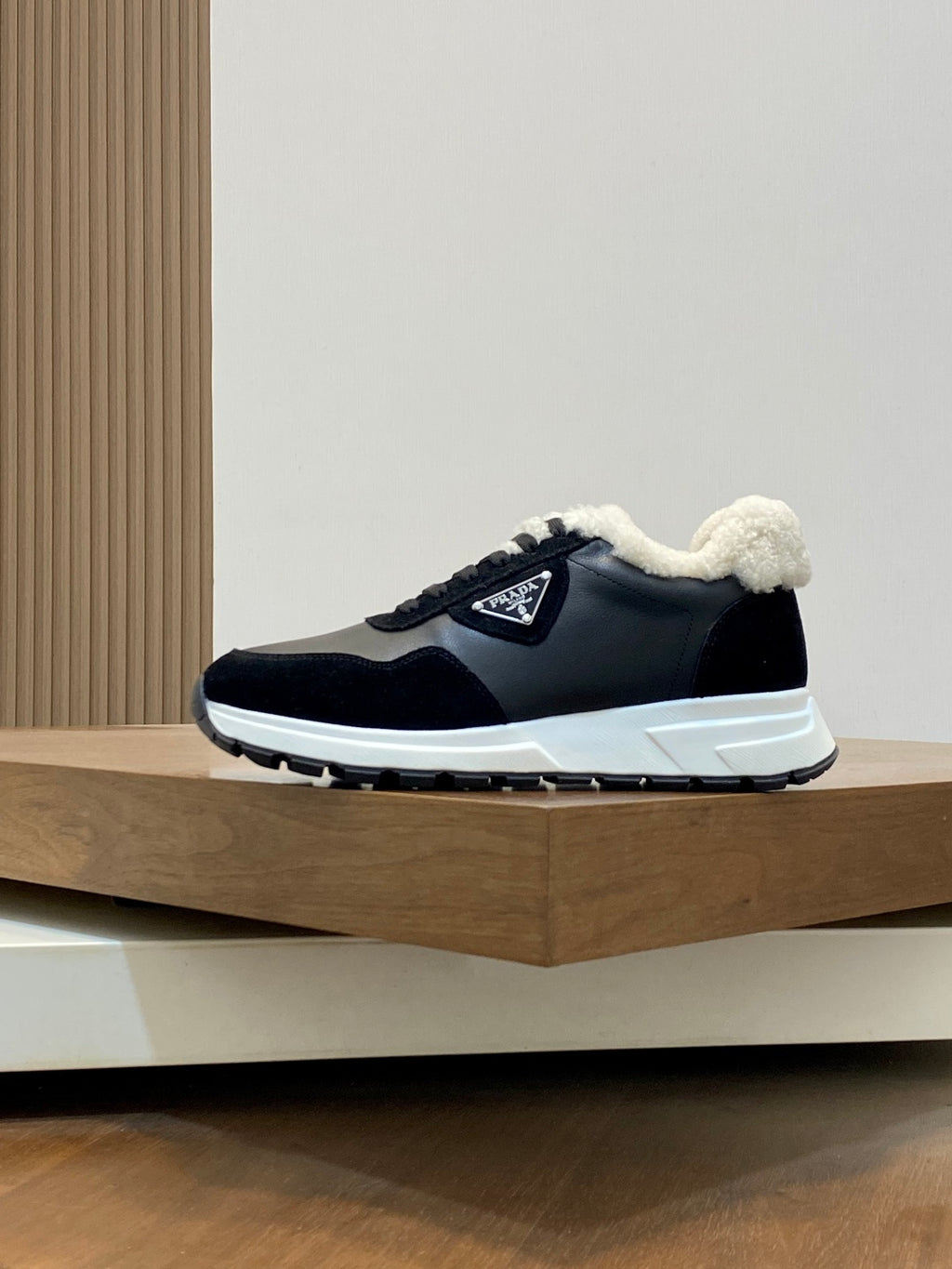 Prada unisex lace-up shoes in black with plush sherpa lining and white sole