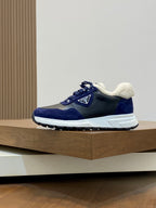 Prada unisex lace-up sneakers, dark blue upper with sherpa lining and white rubber sole.