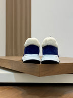 Prada unisex sneakers from the back: dark blue uppers with white soles and plush collars.