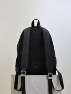 YSL black backpack with adjustable shoulder straps and small front label