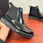 Prada chelsea boot held in hand, glossy black leather with elastic side panel