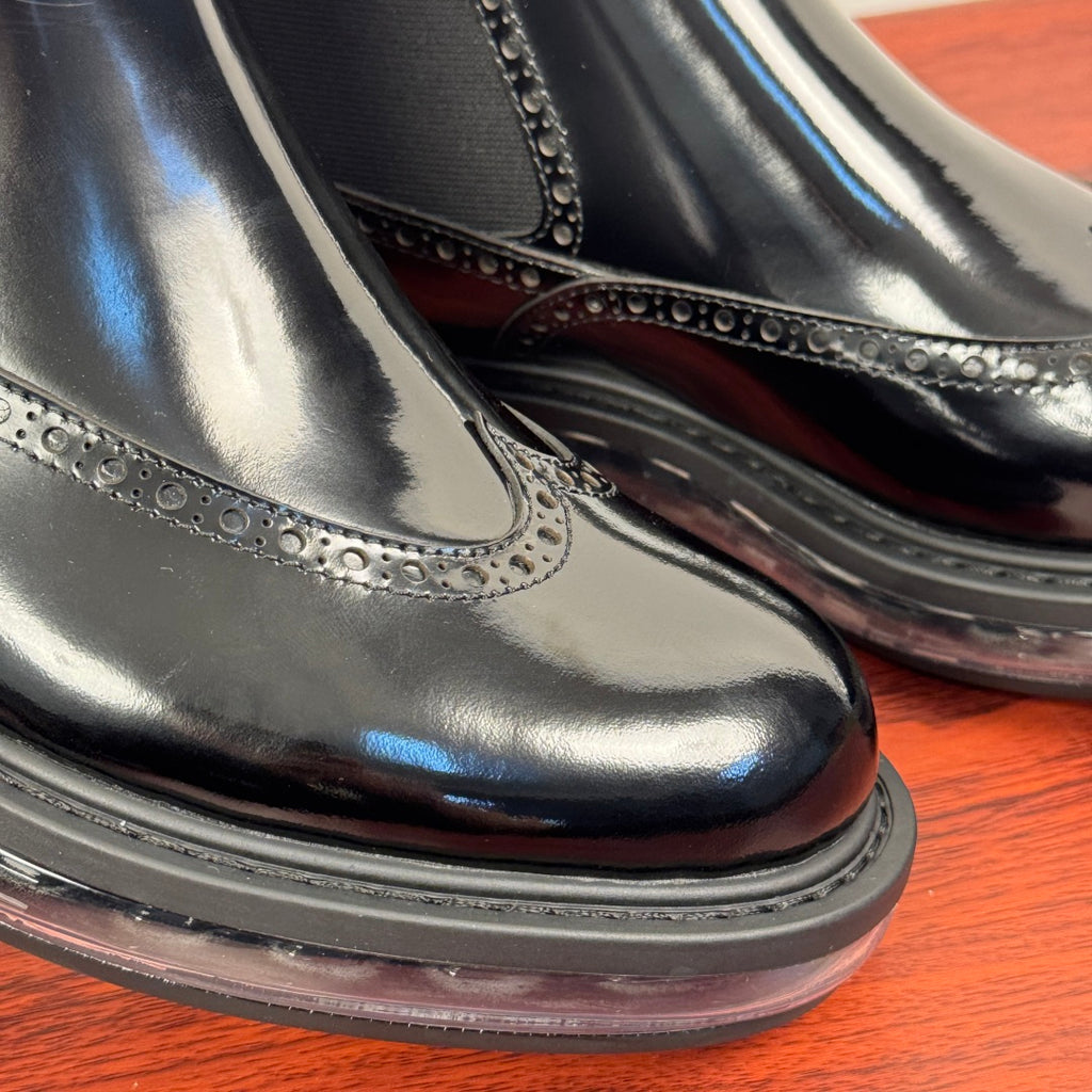 Prada chelsea boot toe detail, glossy black leather with stitched brogue-like trim