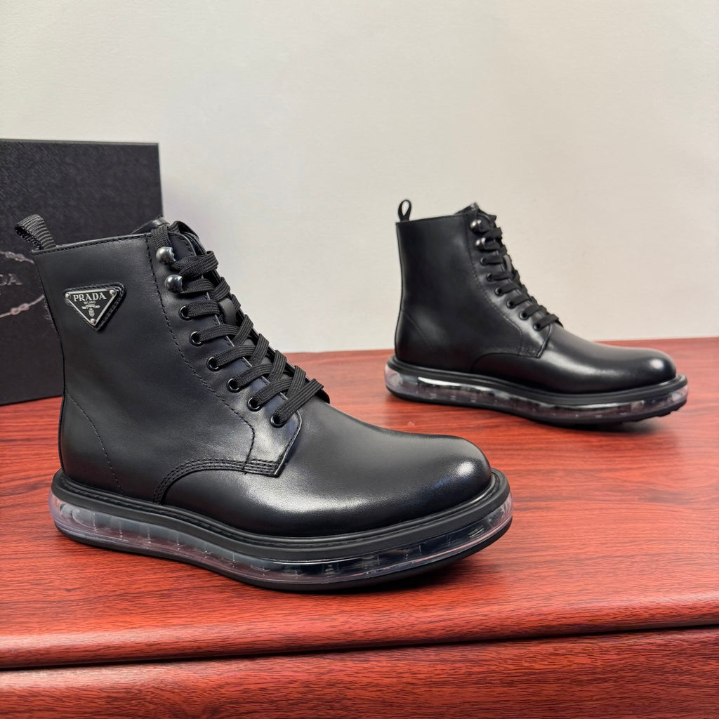 Black leather lace-up ankle boots with rubber sole and Prada logo patch.