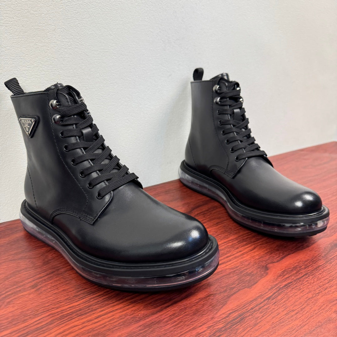 Black leather lace-up ankle boots pair, padded collar and rubber sole.