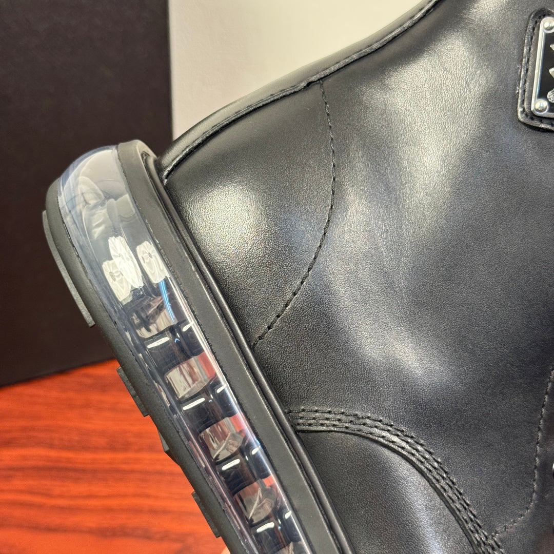 Black leather ankle boot close-up of side panel and lace guard stitching.