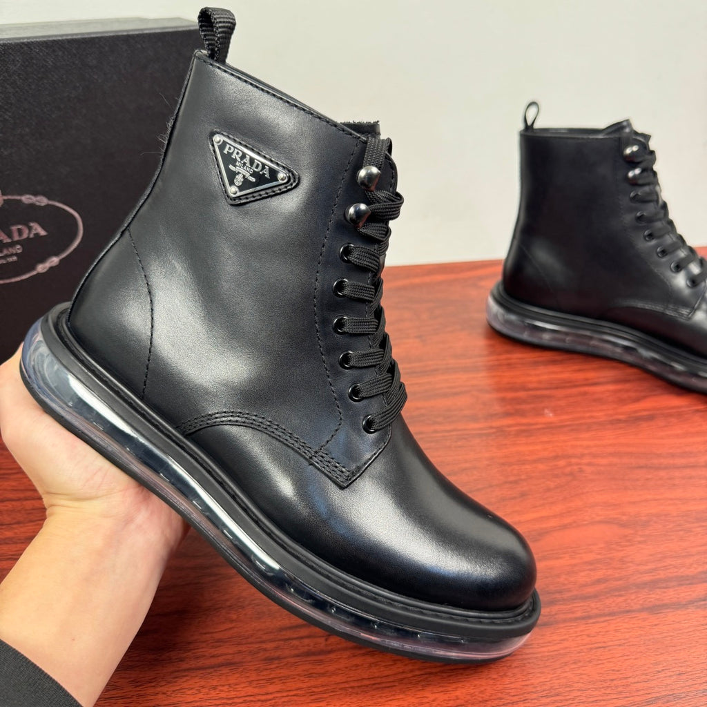 Black leather lace-up ankle boot with Prada logo badge and metal eyelets.