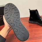 Black rubber boot outsole with PRADA logo and textured tread