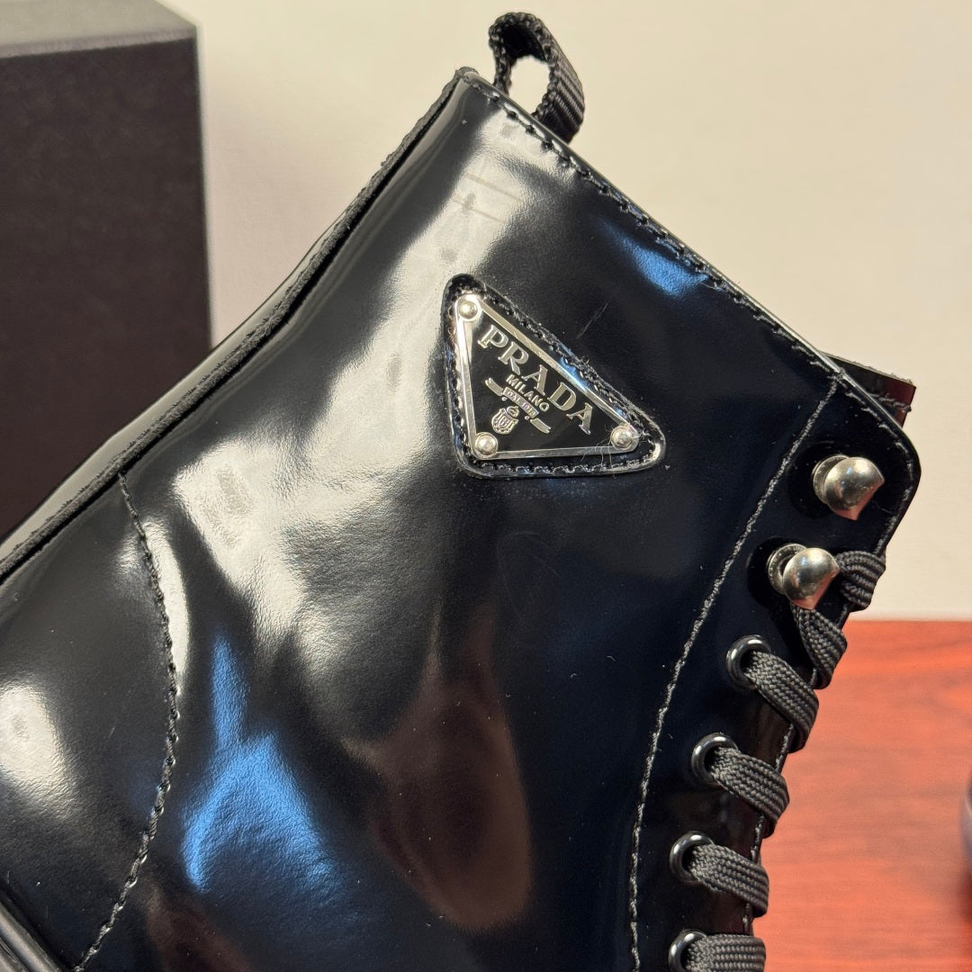 Black ankle boot with Prada triangle side logo and lace-up panel
